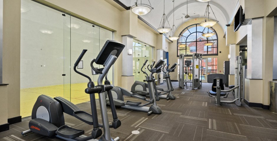 Luxury apartments with huge fitness center with multiple varieties of workout equipment, free weights, yoga and spin rooms at The Lanesborough Apartments in Houston.