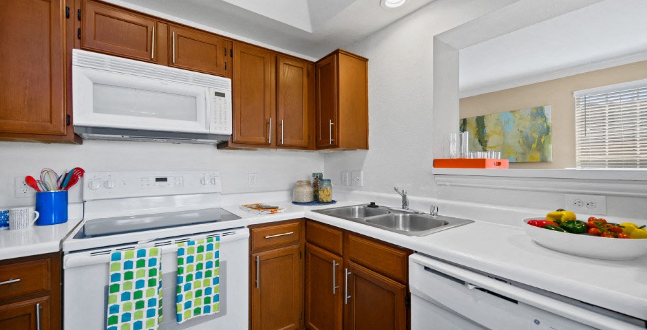 Luxury apartments with spacious kitchens, custom home cabinets, recessed ceiling and side-by-side refrigerators at The Lanesborough Apartments in Houston.