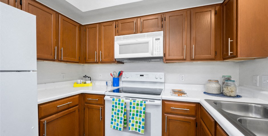 Luxury apartments with spacious kitchens, custom home cabinets, recessed ceiling and side-by-side refrigerators at The Lanesborough Apartments in Houston.