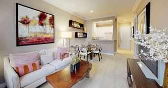 Spacious living room, spacious dining room, kitchen with granite countertops, white cabinets, and breakfast bar at Tuscany Court Apartments in Houston.