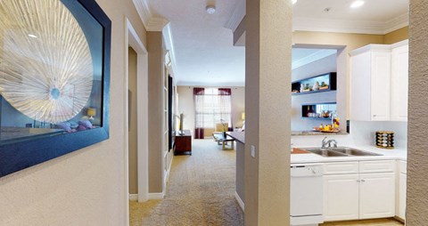 Spacious living room, spacious dining room, kitchen with granite countertops, white cabinets, and breakfast bar at Tuscany Court Apartments in Houston.