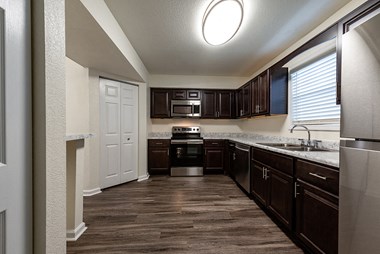 Kitchen with Dark Cabinets and Stainles Steel Appliances