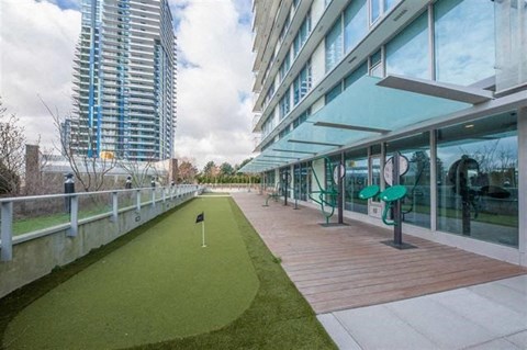 A golf course is situated on a rooftop patio.