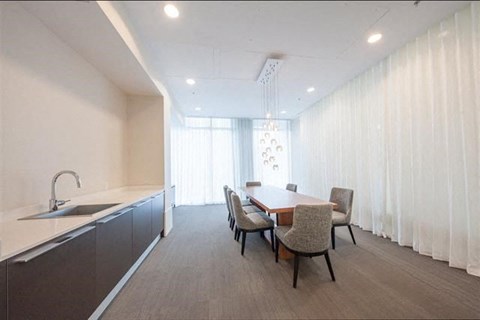 A modern kitchen with a dining table and chairs.