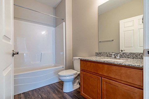 a bathroom with a toilet and a shower and a sink