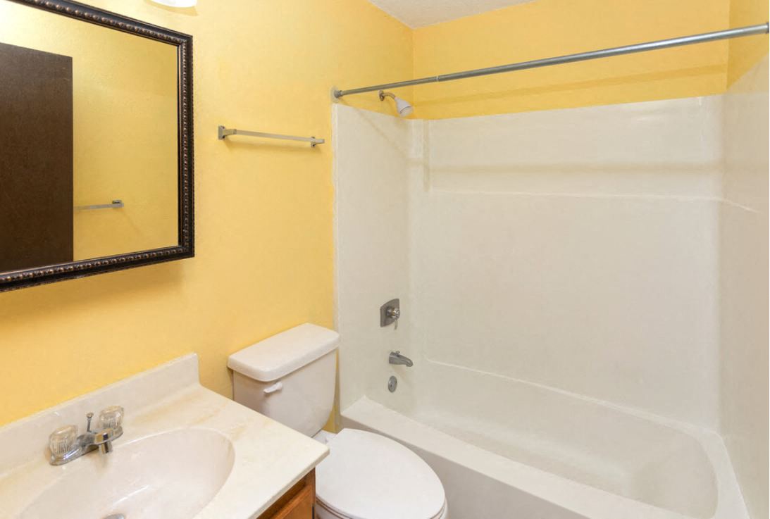 a bathroom with a shower and a sink and a toilet