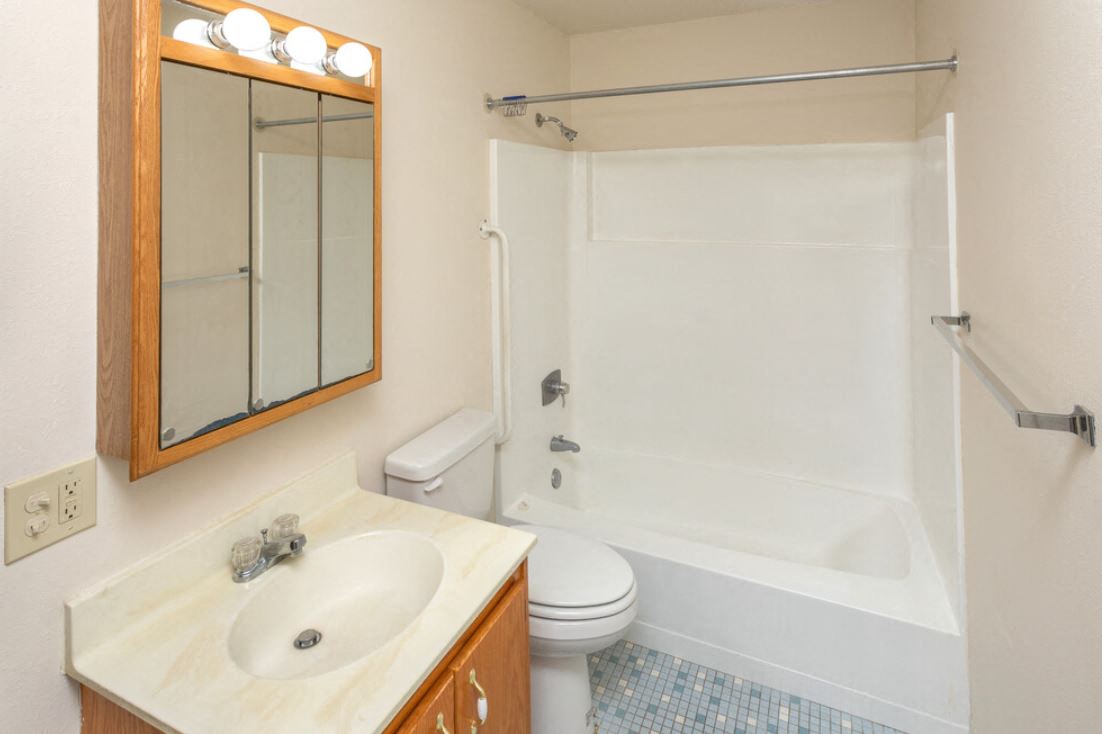 a bathroom with a sink toilet and a shower