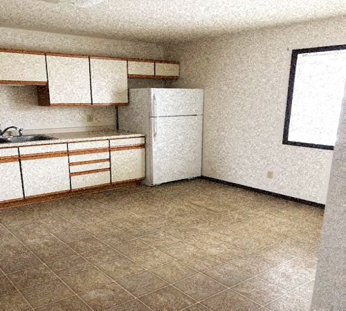 A kitchen with a white refrigerator and brown cabinets.