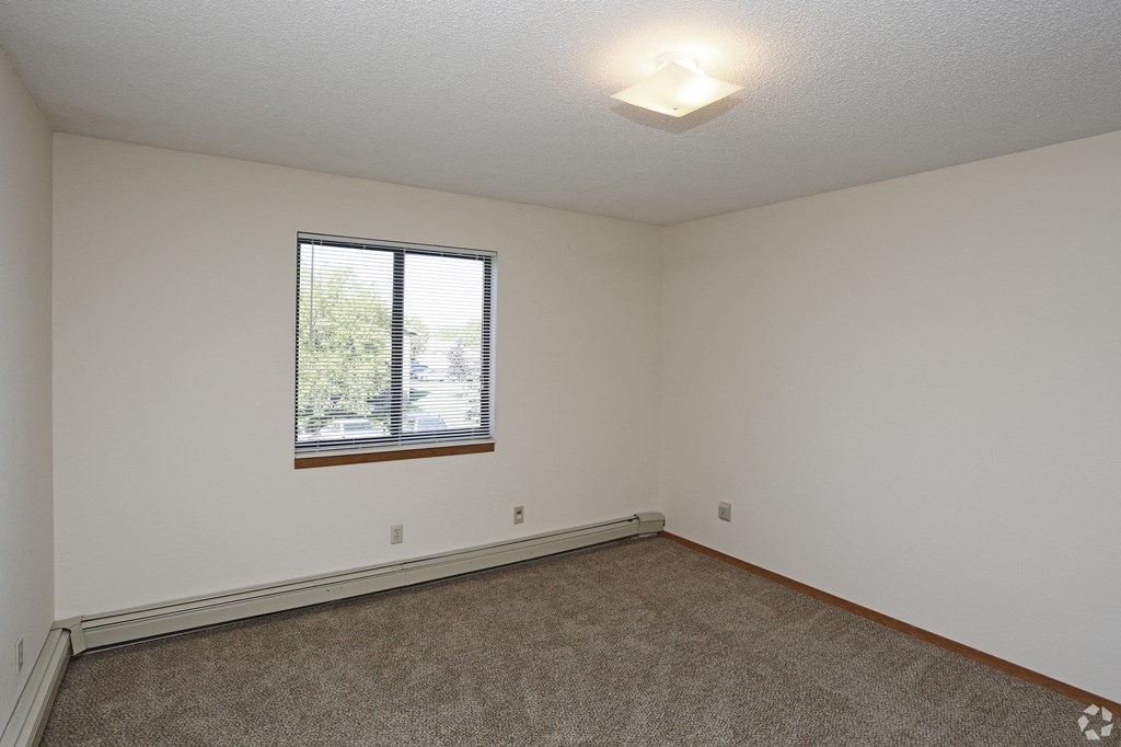 the living room of an empty house with a window