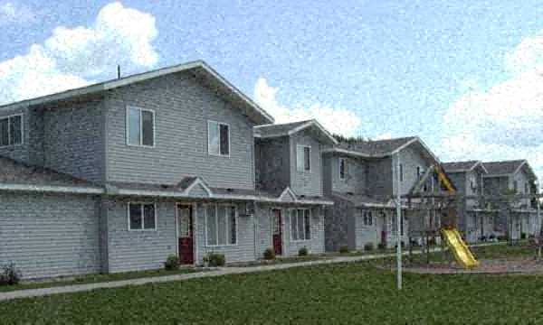 a row of houses with a playground in the yard