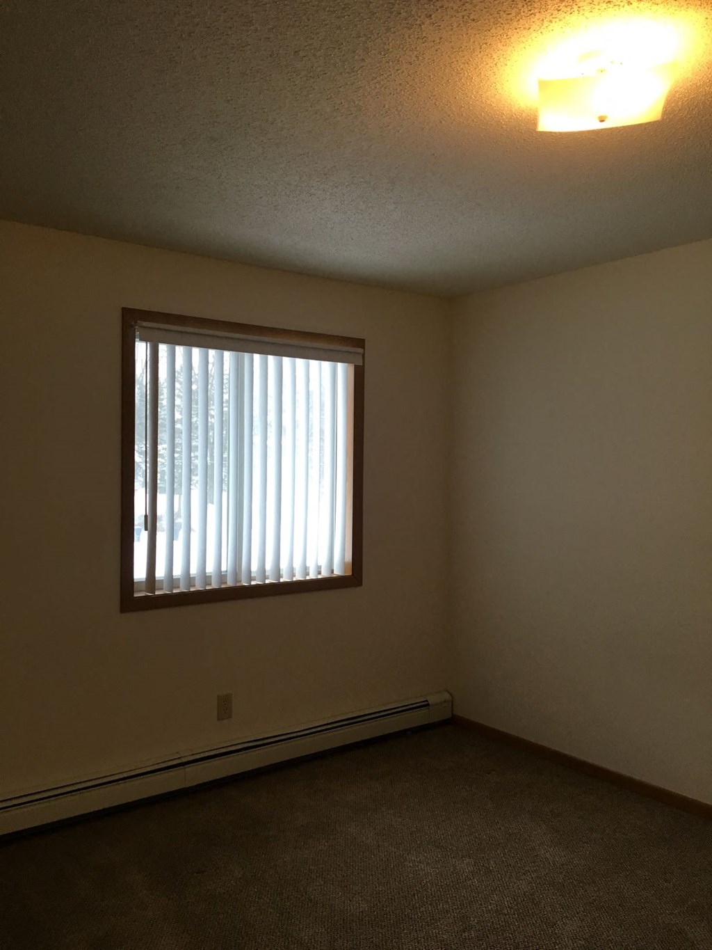 the living room of an empty house with a window
