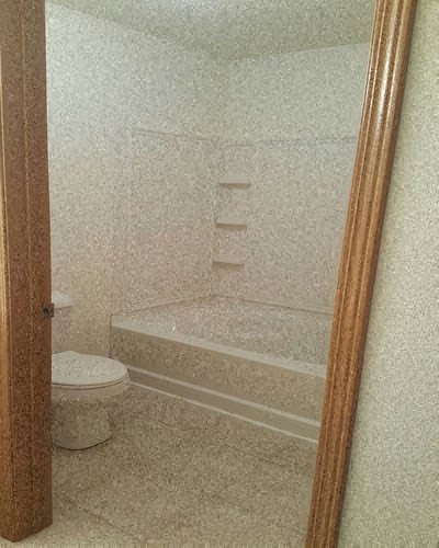 a small bathroom with a toilet and a bath tub