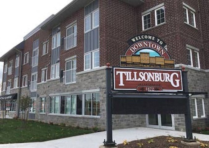 a sign in front of a large brick building