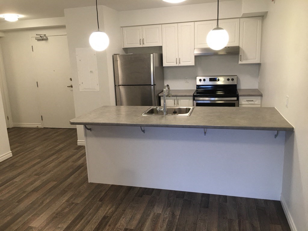 a kitchen with a counter top and a refrigerator