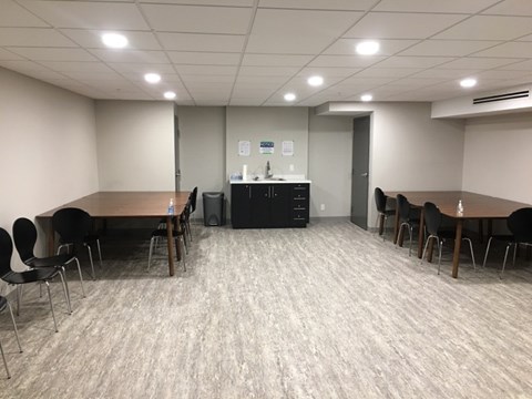 A conference room with a long table and chairs.