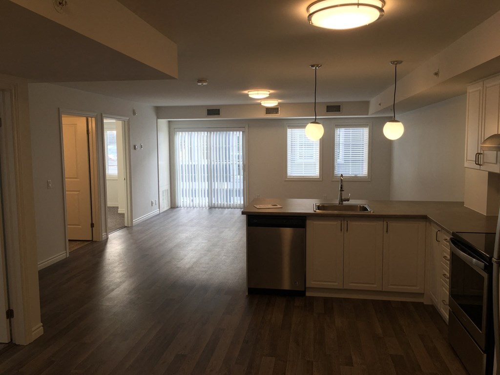 an empty kitchen and living room in an empty house