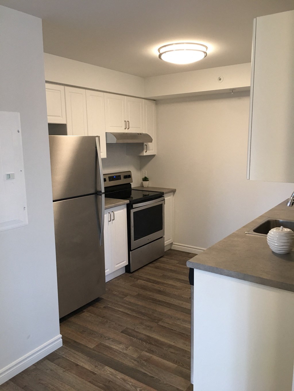 a kitchen with stainless steel appliances and white cabinets