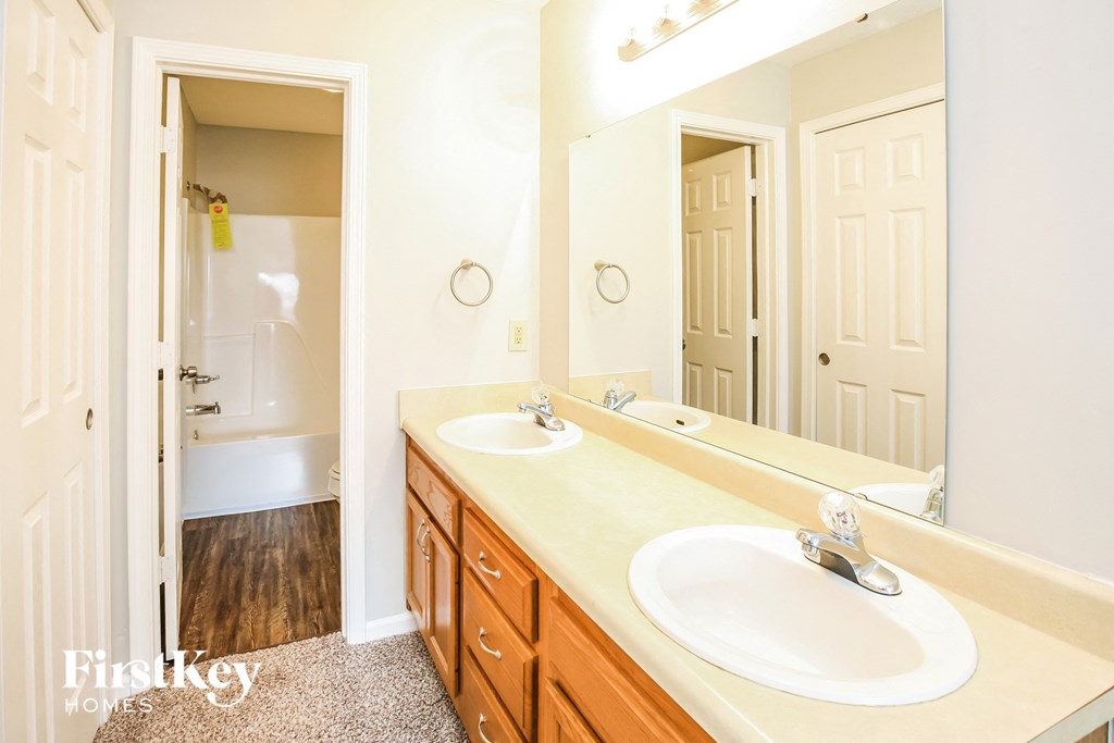 a bathroom with two sinks and a large mirror
