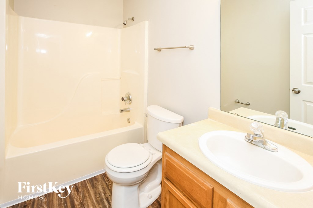 a bathroom with a sink toilet and a tub