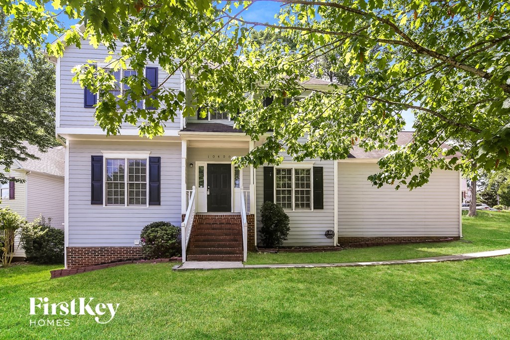 A house with a white and grey exterior is shown with the logo "FirstKey Homes" on the bottom left.