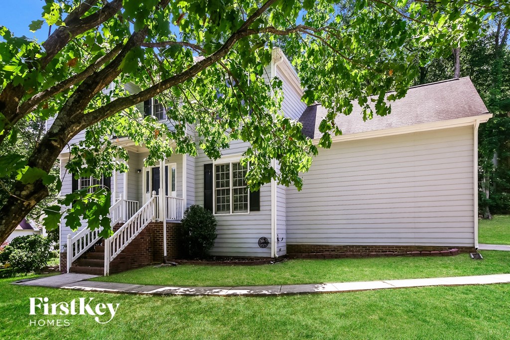 A house with a tree in front of it.
