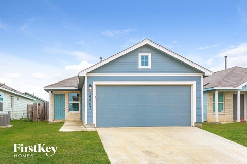 A blue house with a garage door numbered 0807.