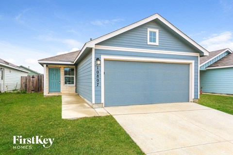 A blue house with a garage door numbered 0807.