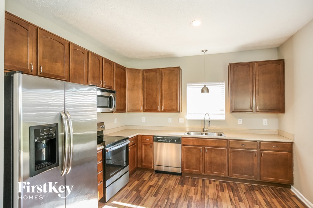a kitchen with wooden cabinets and stainless steel appliances