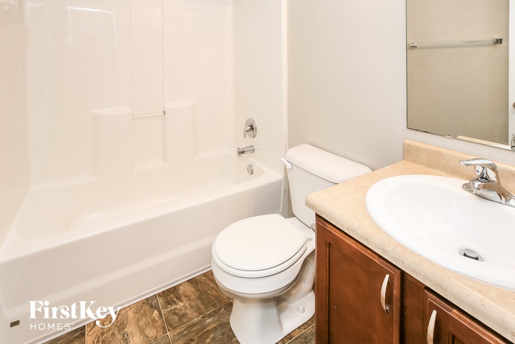 a bathroom with a toilet and a sink and a tub