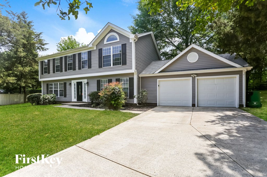 a white and gray house with a white garage door