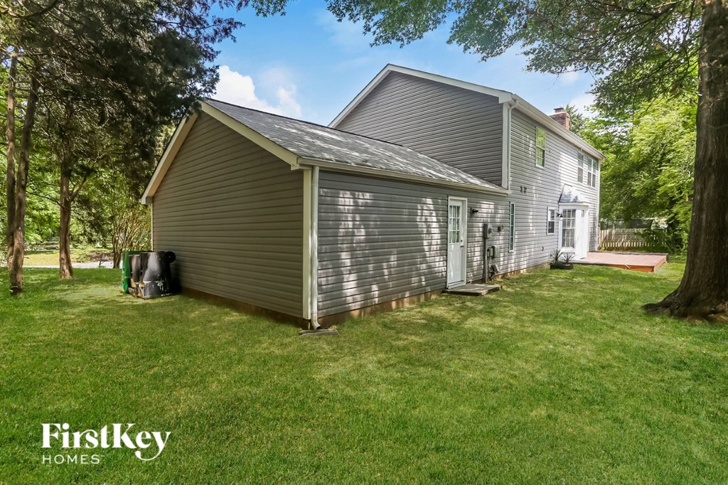 a side view of a house with a garage and a yard