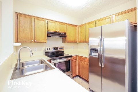 A kitchen with wooden cabinets and stainless steel appliances.