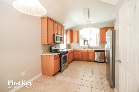 a kitchen with wooden cabinets and stainless steel appliances