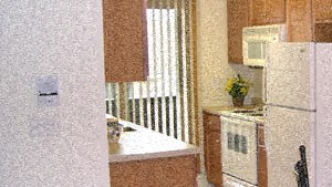 a kitchen with a table and chairs and a refrigerator