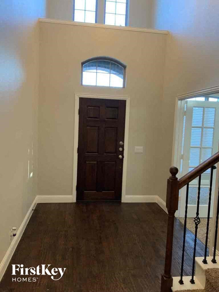 a view of a door from the bottom of a staircase