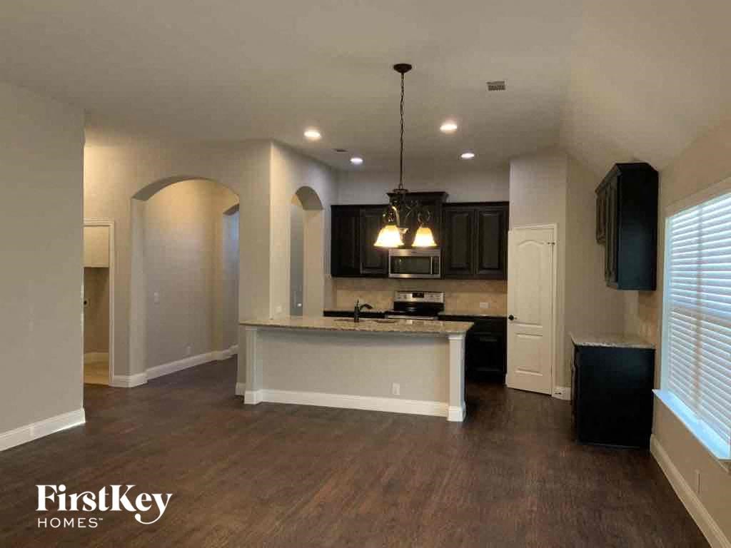 an empty kitchen with a counter top and a