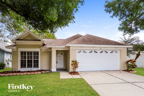 a house with a white garage door and a driveway