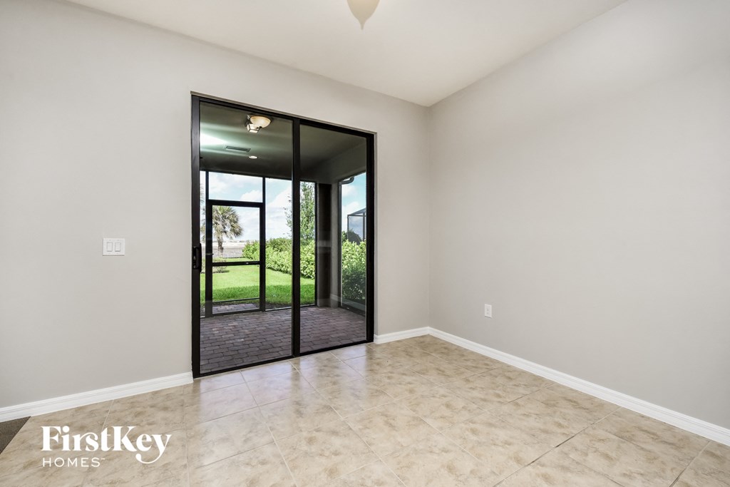 an empty living room with a sliding glass door to the yard