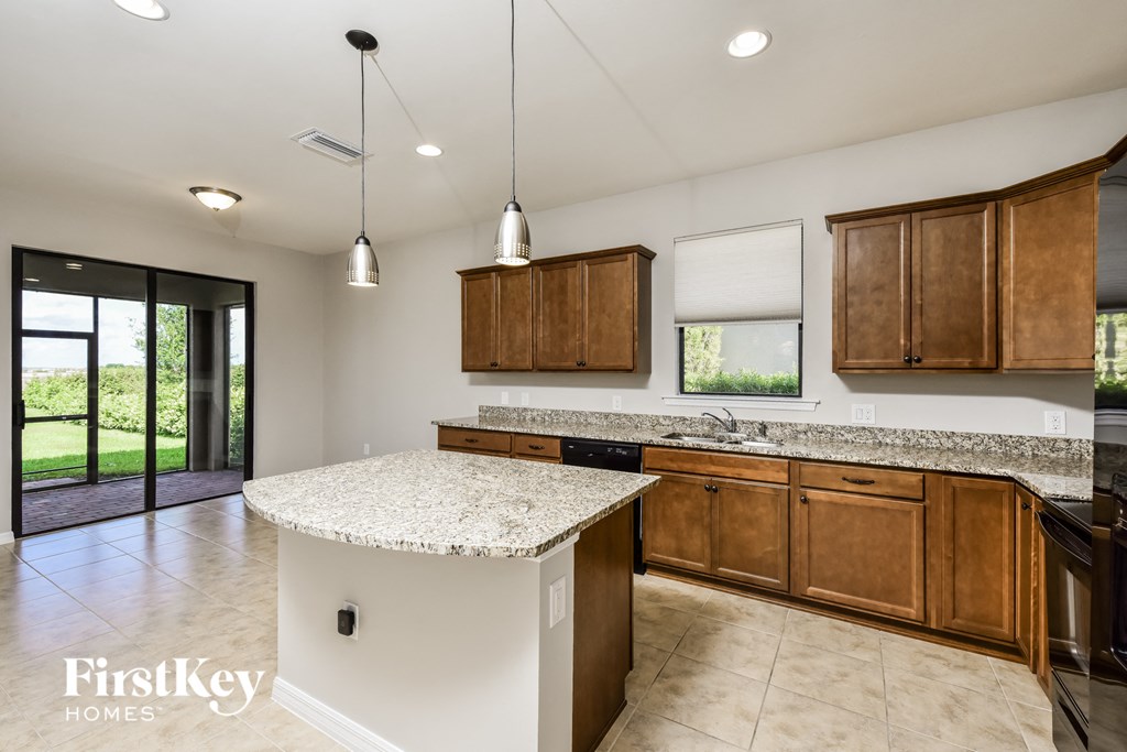 an island in the center of a kitchen with wooden cabinets