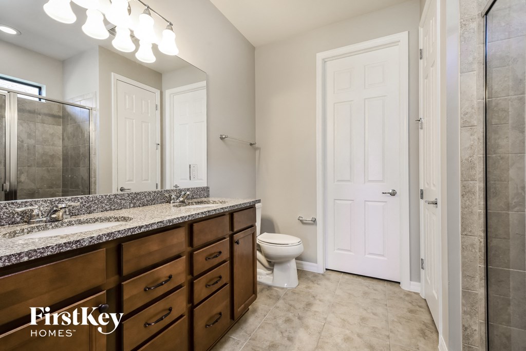 a bathroom with a toilet and a sink and a mirror