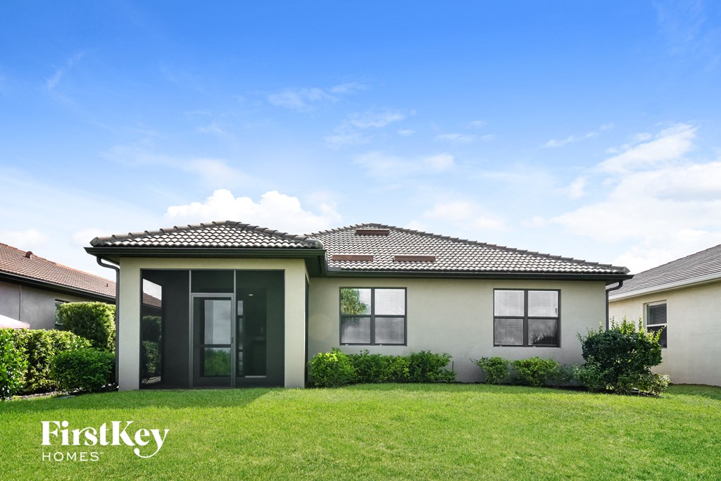 a house with a green lawn and a blue sky