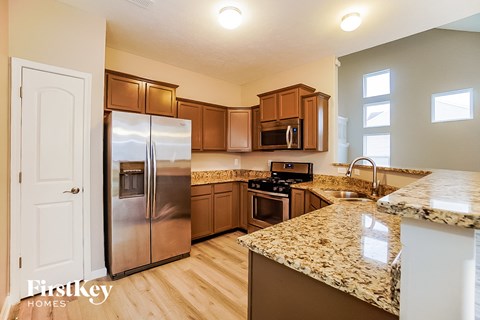 a kitchen with stainless steel appliances and granite counter tops