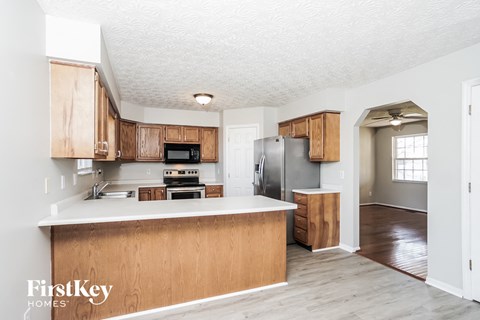 A kitchen with wooden cabinets and a countertop.