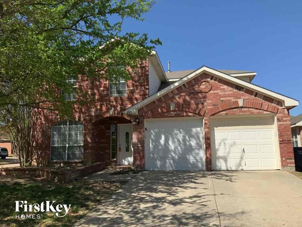a red brick house with a white garage door