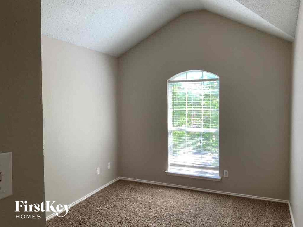 an empty living room with a large window