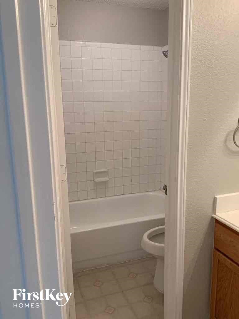 a bathroom with a toilet and a tub and a sink