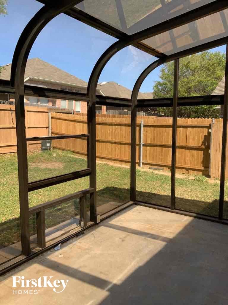 a view of the backyard from the inside of a gazebo