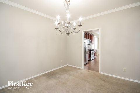 a living room with a carpet and a chandelier