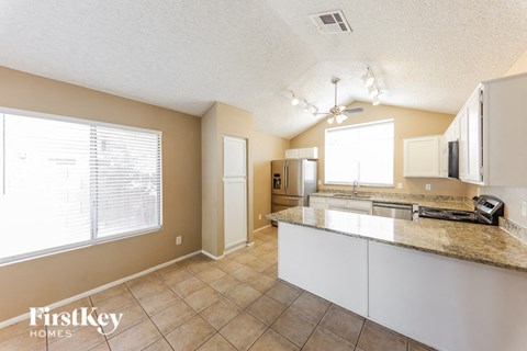 a kitchen with a counter top and a large window