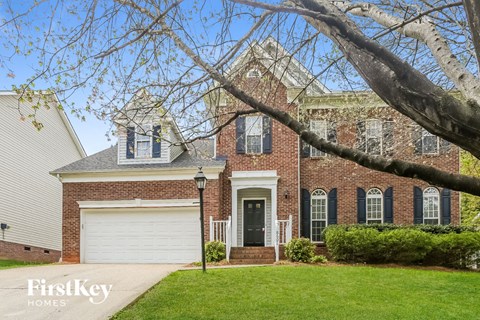 a large brick house with a white garage door